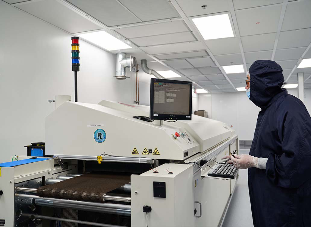 Micross employee working on a reflow oven